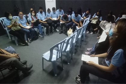 3. A group of participants sitting in the dark room and listening to instructions on the next activity